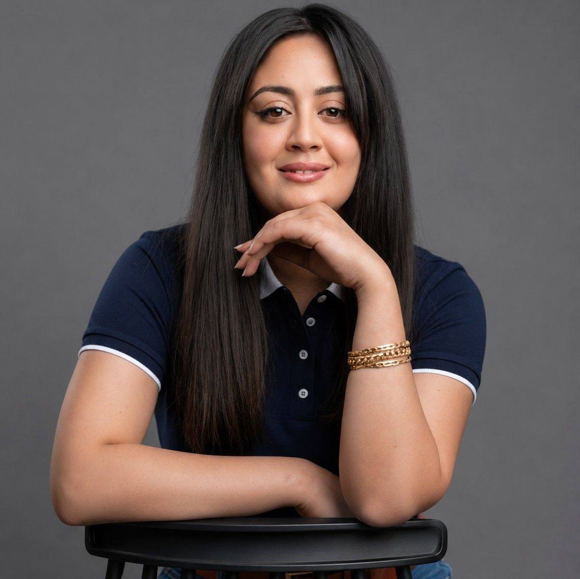 Zahra Dalhoum working at her desk with dual monitors showing design and code files – professional workspace photo